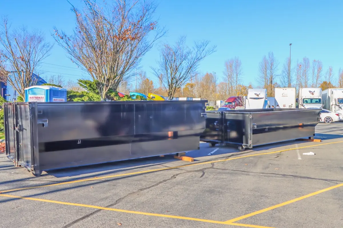 Professional dumpster rental service with roll-off container on residential driveway in Ojai